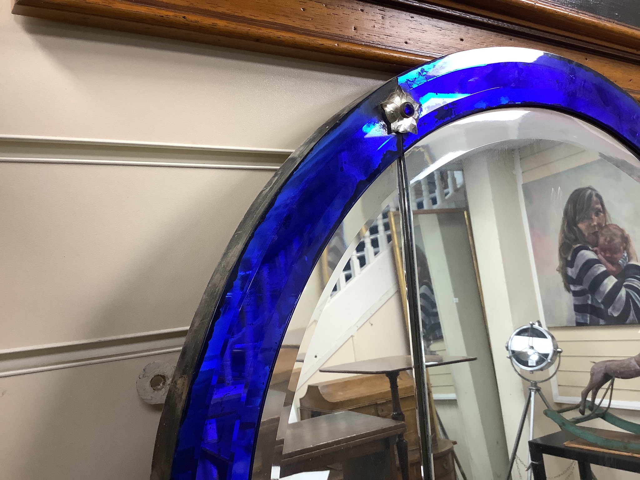 A large arched glass mirror, with blue glass borders